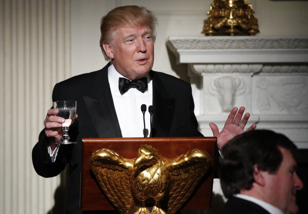President Trump makes a toast during a dinner reception for the annual National Governors Association winter meeting Sunday in the State Dining Room at the White House.