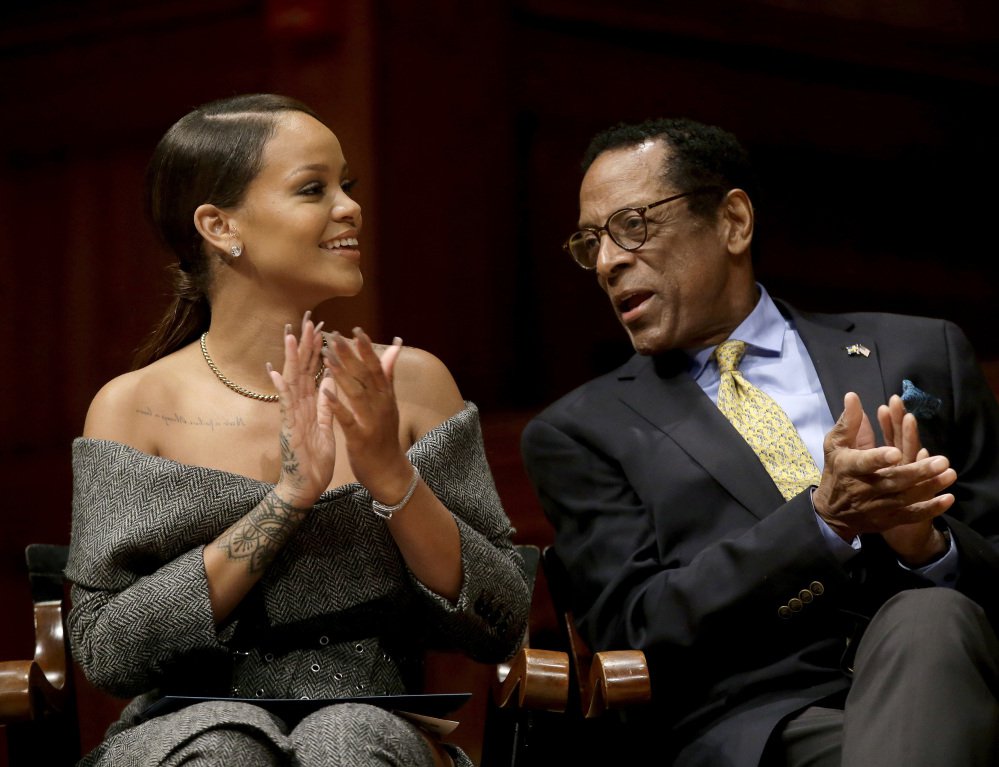Singer Rihanna and Allen Counter, Harvard Foundation director, applaud during Harvard's Humanitarian of the Year Award ceremonies Tuesday in Cambridge, Mass.