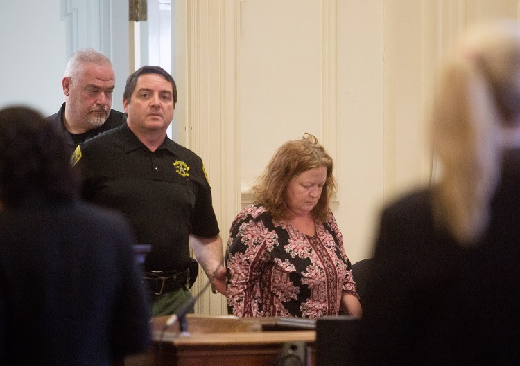 Kandee Weyland is led into the courtroom on Feb. 24 for her first appearance before a judge in the killing of her ex-husband.