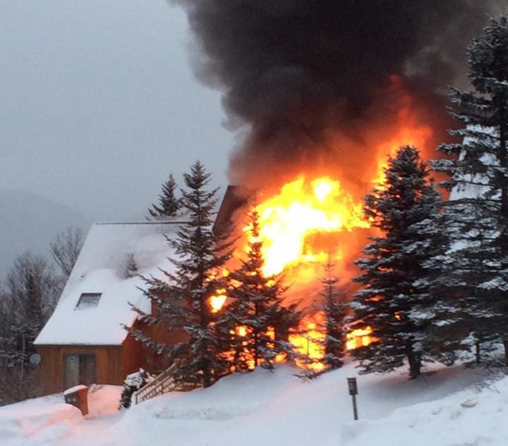 A condominium building burns Tuesday at Saddleback Mountain. 