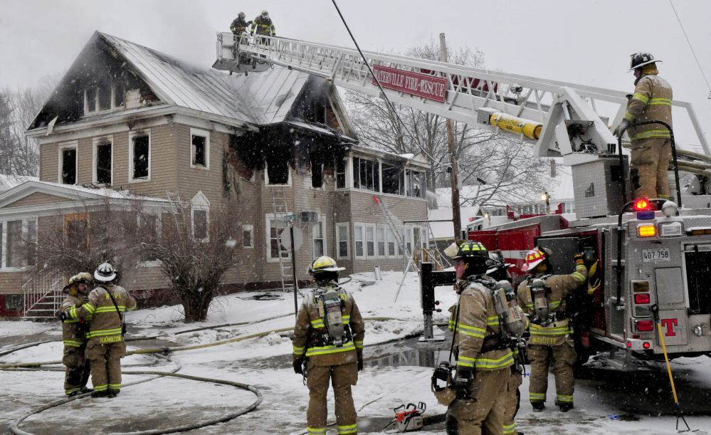 Firefighters continue working Wednesday at the scene of a fire that severely damaged an apartment building in the morning on Summer Street in Waterville.