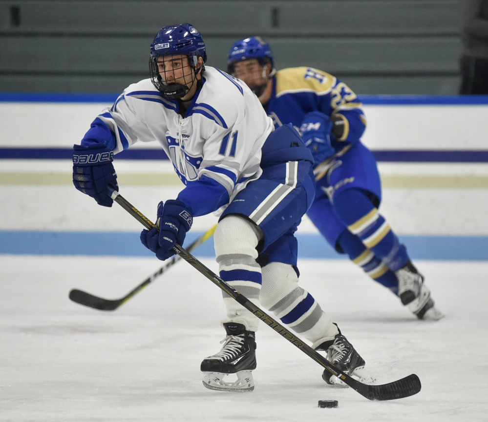 Colby's Kienan Scott skates down the ice in the first period Friday night against Hamilton College.