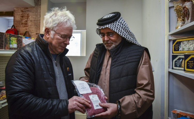 Central Maine Meats co-owner Joel Davis, left, discusses distribution of halal-certified meat with Khalid Zamat, owner of a newly opened Iraqi grocery store in Hallowell. Halal-certified meat is processed at Central Maine Meats in Gardiner.