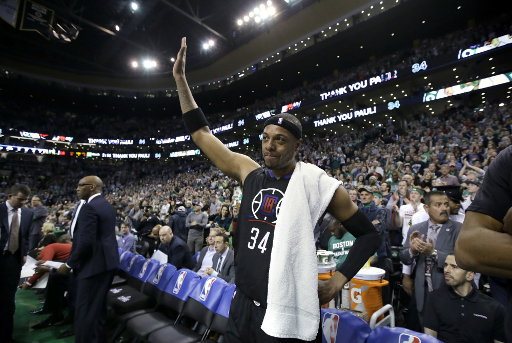 Los Angeles Clippers forward Paul Pierce, center, acknowledges applause from the crowd during a timeout in the first half against the Boston Celtics on Sunday in Boston. Pierce, a former Celtics player, played in what is expected to be his final game in Boston on Sunday.