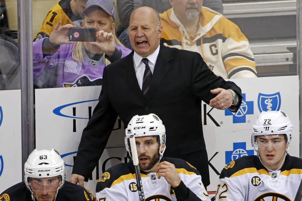 Boston Bruins head coach Claude Julien motions to an official during the first period of a Jan. 22 game against the Penguins in Pittsburgh.