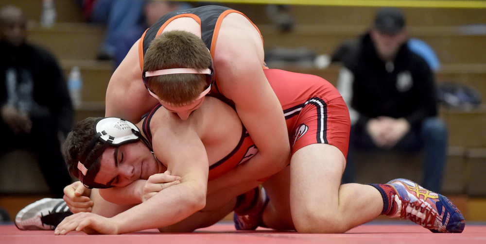 Winslow's Ben Abbott, top, wrestles Cony's Nic Mills in the 195-pound championship bout at the Kennebec Valley Athletic Conference champmionships last Saturday at Mt. Ararat High School in Topsham.