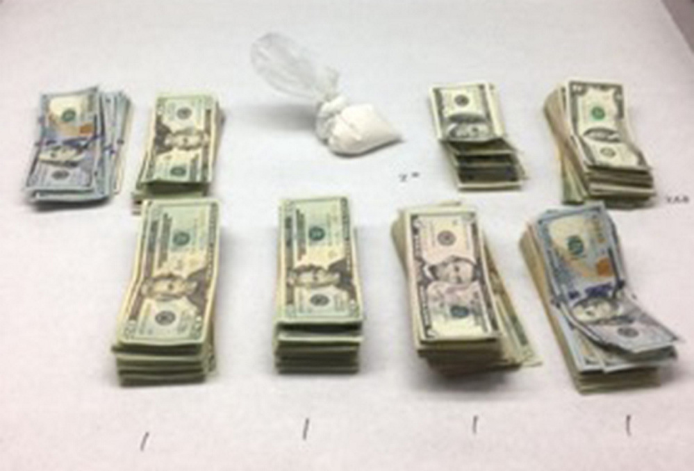 Police said they found this accumulation of cash and drugs Tuesday morning at 51 School St. in Augusta.