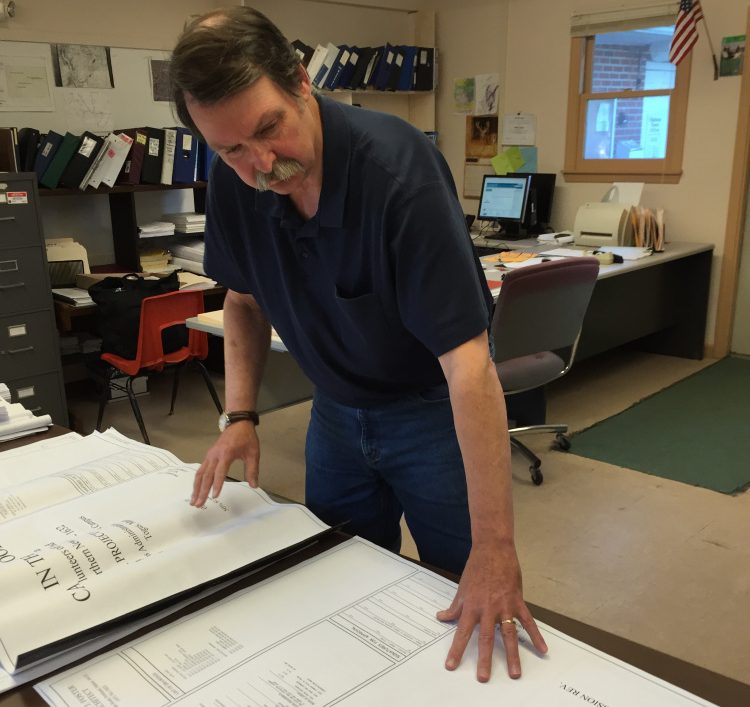 Bill Butler, the code enforcement officer for the town of Chelsea, reviews the plan for the Cabin in the Woods project for homeless veterans in 2016.