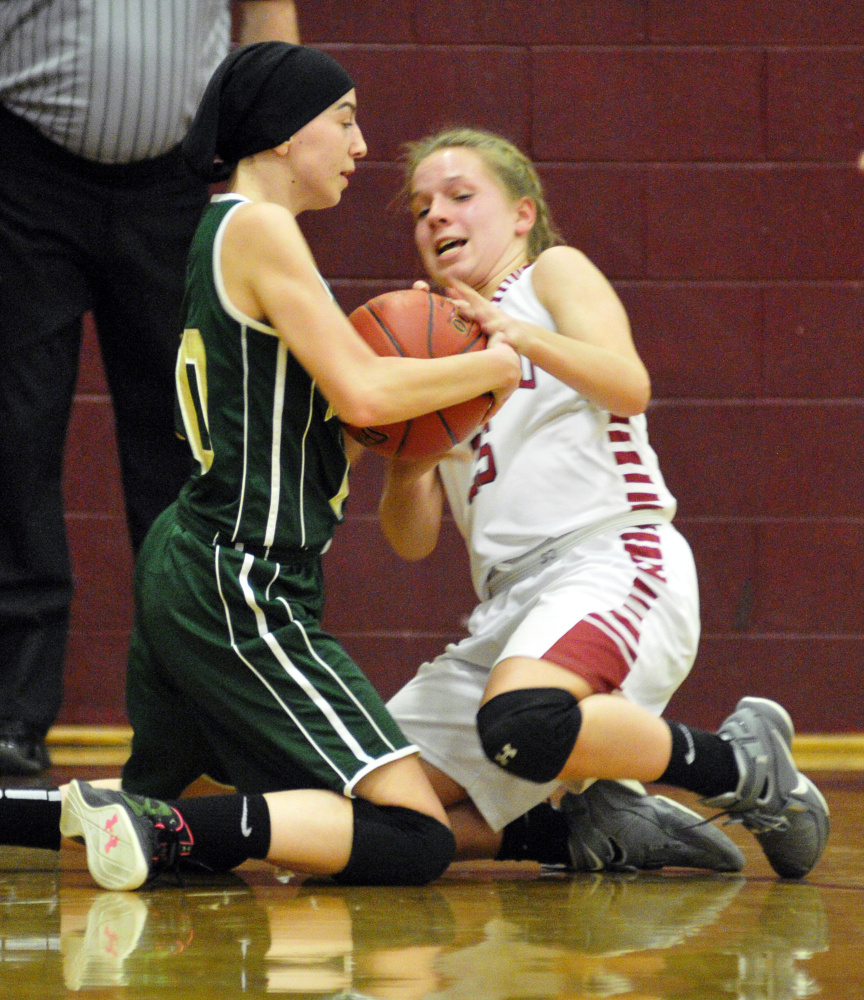 Rangeley's Brooke Egan, left, and Richmond's Caitlin Kendrick wrestle for the ball during a game in Richmond.