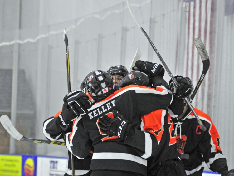 Members of the Gardiner hockey team celebrate a goal in second period of a game against rival Cony on Friday at the Camden National Bank Ice Vault in Hallowell.