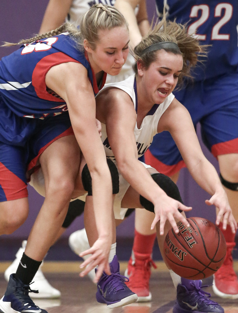 Waterville junior guard Mackenzie St. Pierre and Messalonskee junior guard Ally Turner fight for possession of the ball in the second half of a Kennebec Valley Athletic Conference Class A game Friday night.