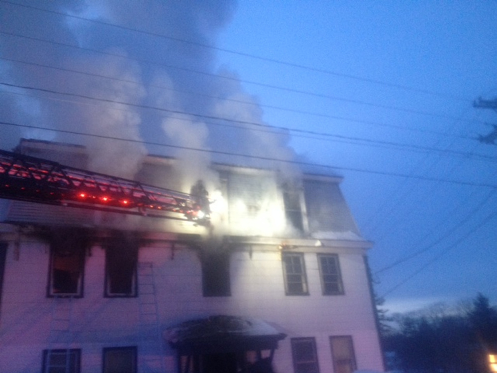 Firefighters work at the scene of a fire Tuesday evening at an apartment building at 11 Main St. in Skowhegan.