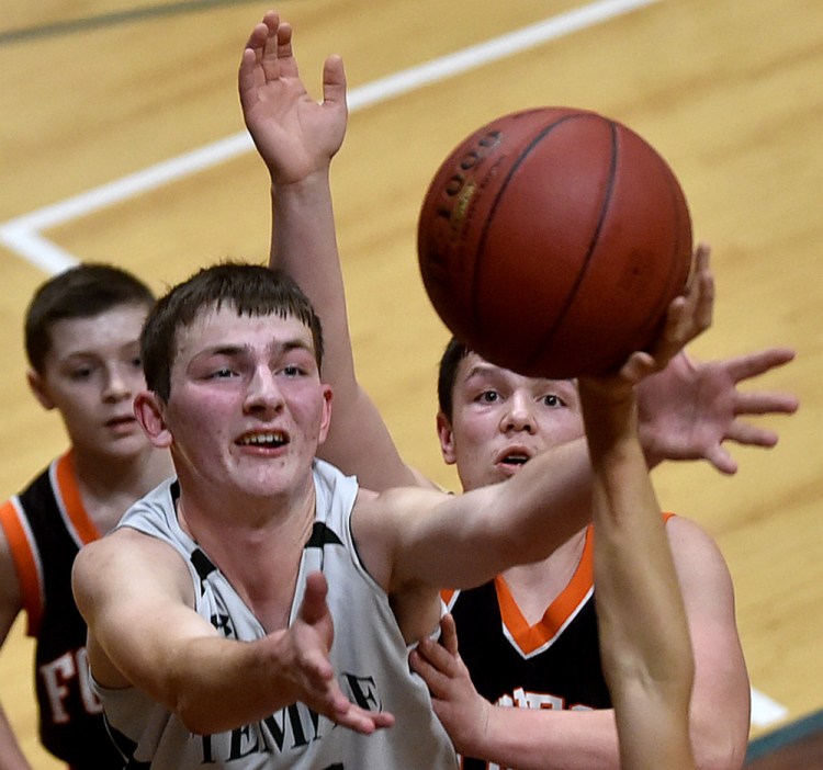 Temple's Brad Smith (12) battles for the rebound against Forest Hills earlier this season at Temple in Waterville.