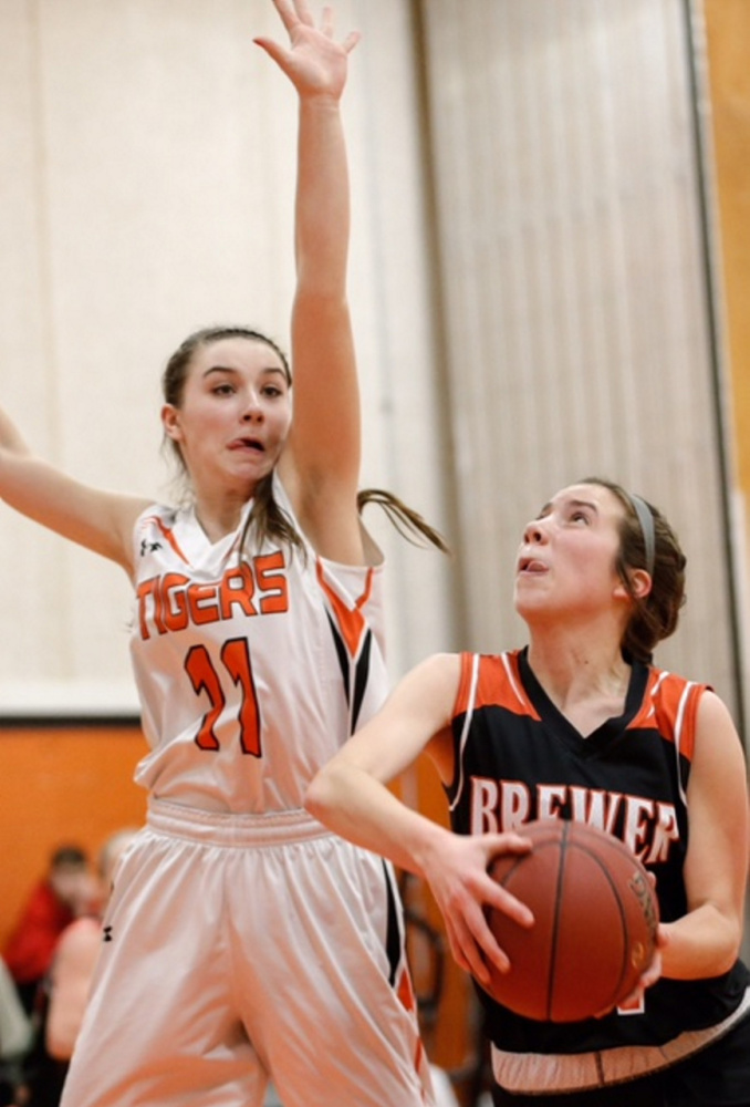 Photo by Dean Denis 
 Gardiner's Leslie Stevens (11) plays tight defense on Brewer's Courtney Pearson during a Class A North preliminary game Tuesday in Gardiner.