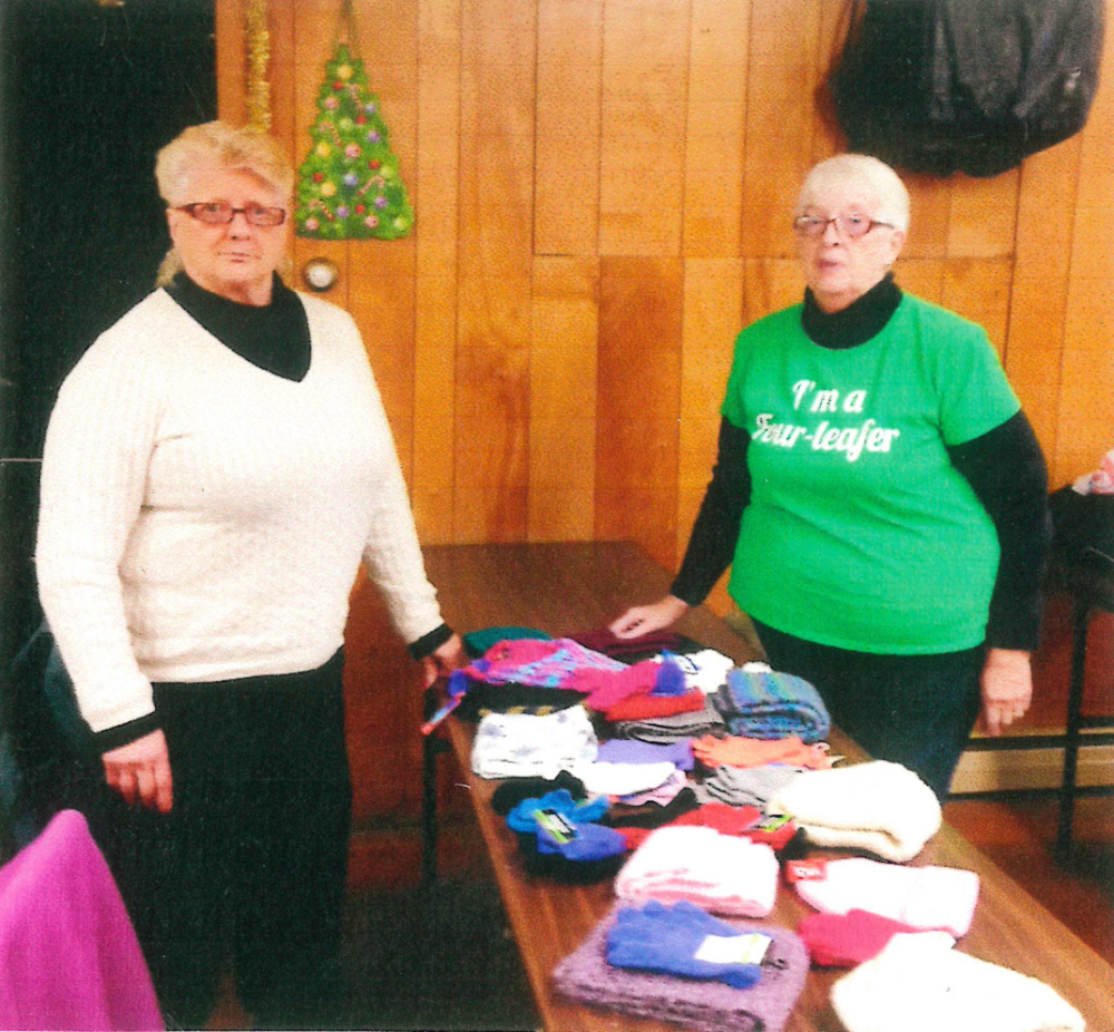 Members of the Four Leaf Clover Senior Club of Gardiner recently were involved in a collection of hats, mittens and scarfs, under the direction of Shirley Cunningham, left, coordinator of the Hat Project with President Johan Brown. The items were presented to the local Head Start Program.