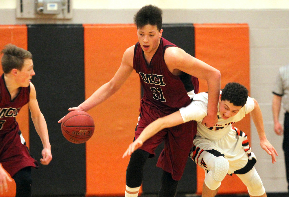 Maine Central Institute's Jose Ignacio Montes Valverde wins a battle for a loose ball with Winslow High School's Jack Morneault during the first half a Class B North prelim game on Thursday night.