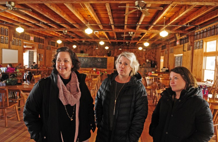 Christa Johnson, director of development at Snow Pond Center for the Arts, left, and Maggi Milligan and Mandy Milligan, from The Lakeside Lodge, talk about petitioning to change liquor rules during an interview Thursday in the lodge at Snow Pond Center for the Arts.