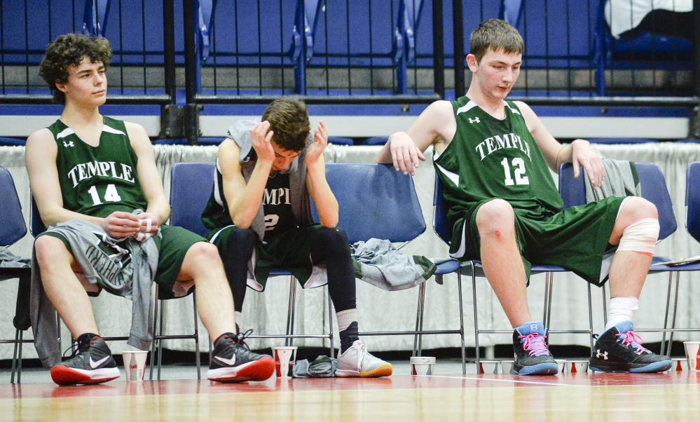 Temple players, from left, Noah Shepard, Micah Riportella and Bradley Smith take in the waning seconds of a 76-63 loss to A.R. Gould in a D South quarterfinal game Saturday morning at the Augusta Civic Center.