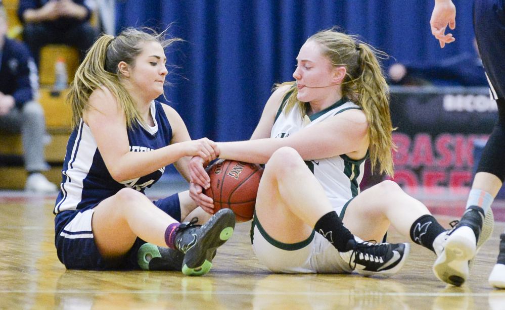 Greenville's Jordan Mann fights to get the ball from Temple's Daphne Labbe during the second half of a Class D South quarterfinal Saturday in Augusta. Temple topped the Lakers 42-40.