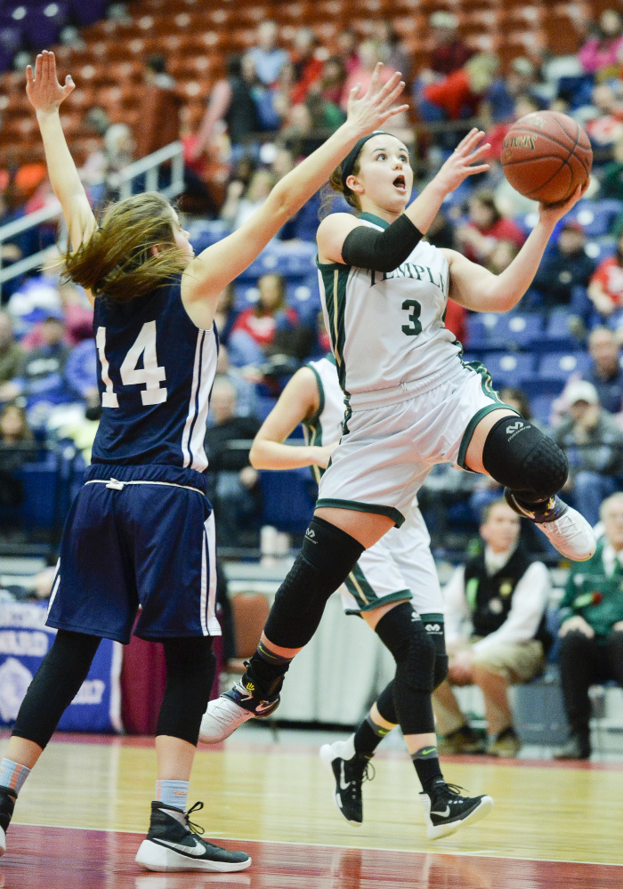 Veronica Rossignol soars to the basket to make a shot past Greenville  defender Morgan Noyes during a Class D South quarterfinal game Saturday morning at the Augusta Civic Center