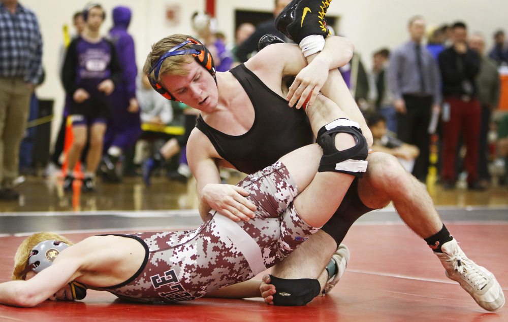 Cody Craig of Skowhegan turns Sam Martel of Noble for the pin in the 106-pound weight class finals at the Class A state championships Saturday at Camden Hills Regional High School.