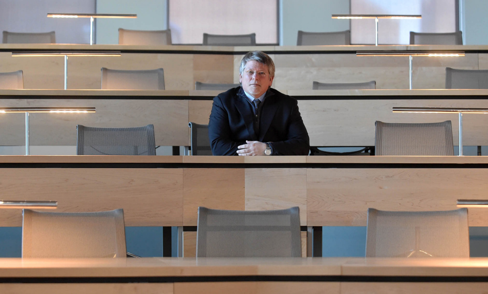 Rick Hopper, president of Kennebec Valley Community College, sits in a new lecture hall at the new Alfond Campus.