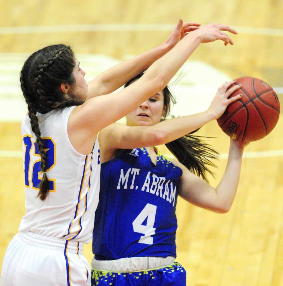 Boothbay's Kate Friant, left, defends Mt. Abram guard Lindsay Huff during a Class C South quarterfinal game Monday at Augusta Civic Center.