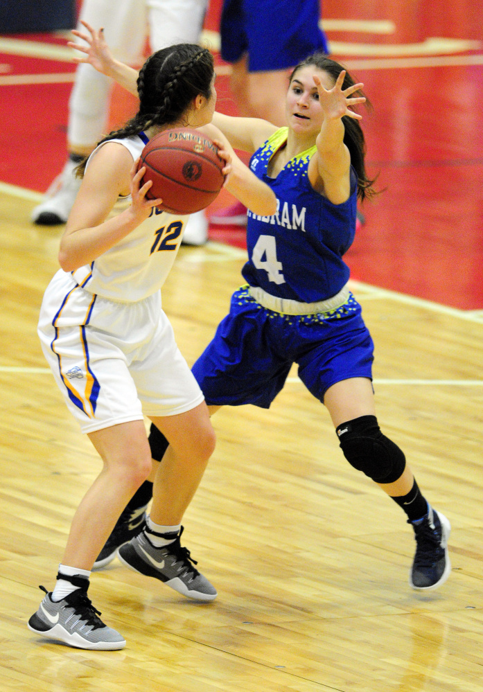 Boothbay's Kate Friant, left, looks to pass around as Mt. Abram guard Lindsay Huff defends during a Class C South quarterfinal game Monday at Augusta Civic Center.