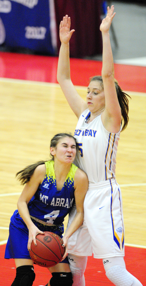 Mt. Abram's Lindsay Huff slams into Boothbay defender Page Brown during a Class C South quarterfinal game Monday at Augusta Civic Center.