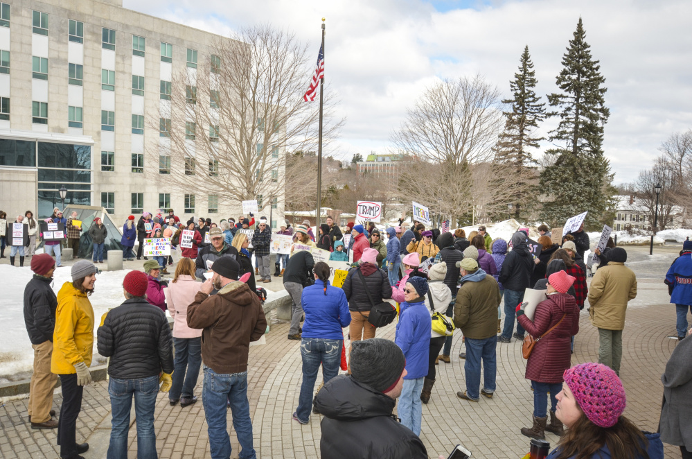 Protesters gather Monday at the State House in Augusta to voice their objections to President Donald Trump. The protest, called Not My President's Day and held on Presidents Day, drew a crowd of participants from across the state.