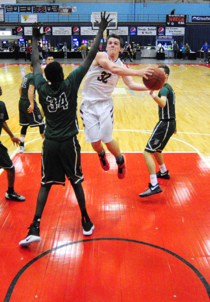 Waynflete's Yai Deng, left, defends Richmond's Matt Holt during a Class C South quarterfinal game Monday at the Augusta Civic Center.