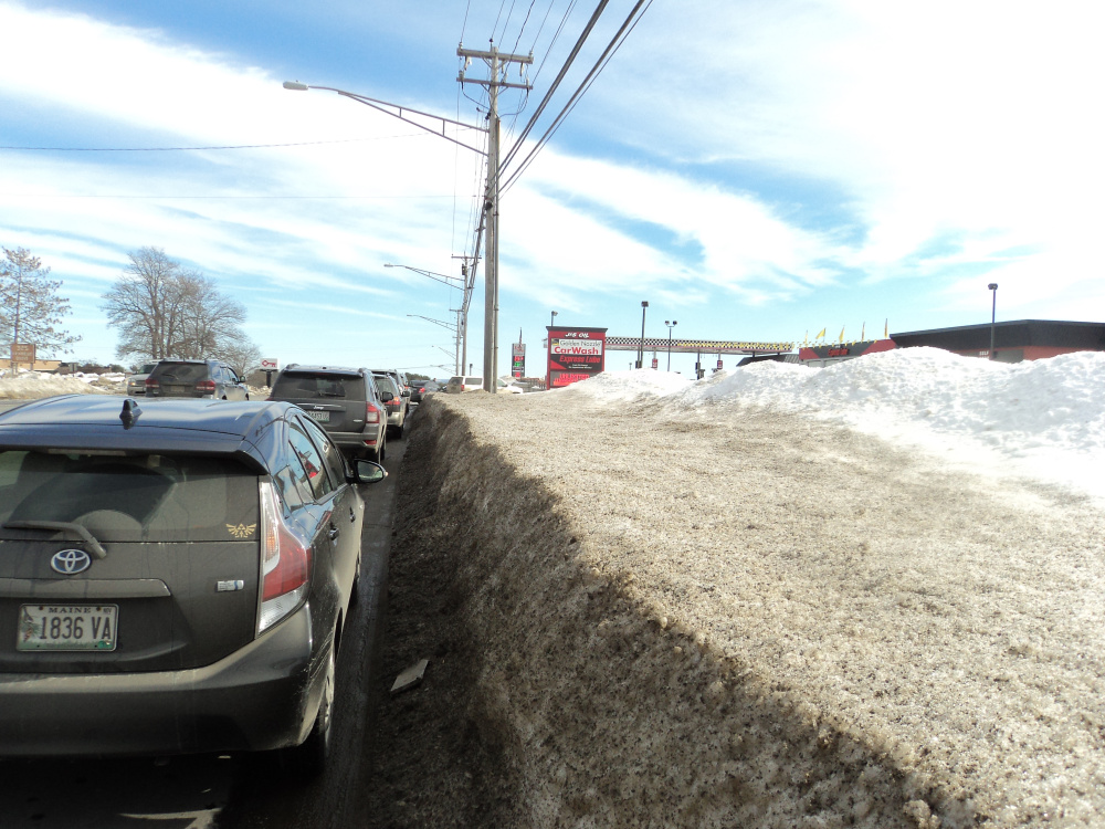 A line of vehicles waits to use the car wash Tuesday at J&S Oil off Kennedy Memorial Drive in Waterville. The photo was taken by a police officer who was patrolling the area and asking people to move.