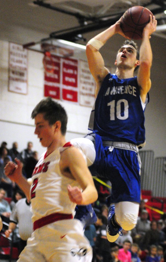 Lawrence senior Mason Cooper, top, shoots over Cony defender Taylor Heath during a Jan. 27 game in Augusta.