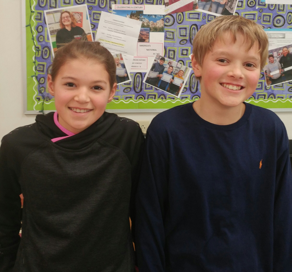 Courtney Cowing, left, a Windsor Elementary sixth grade student, was named the winner of the Canines for Charity National Essay and Art Contest for grades 6-8. Carson Appel, also a Windsor Elementary student, was named runner-up.