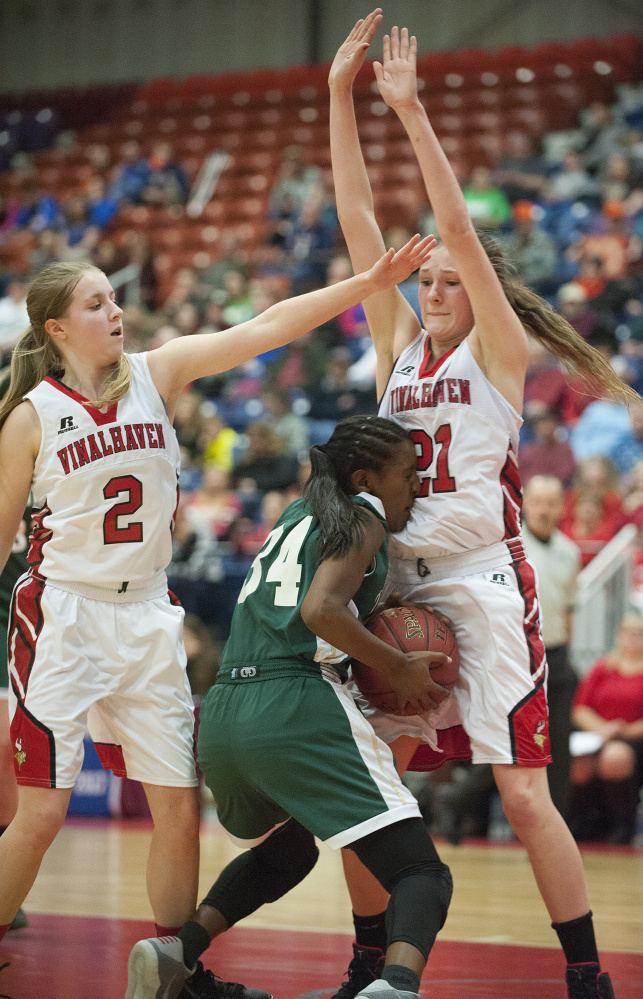Temple's Selam Heinrich runs into a defensive wall created by Vinalhaven's Gilleyanne Davis-Oakes, right, and Ashlyn Littlefield during a Class D South semifinal Thursday at the Augusta Civic Center.