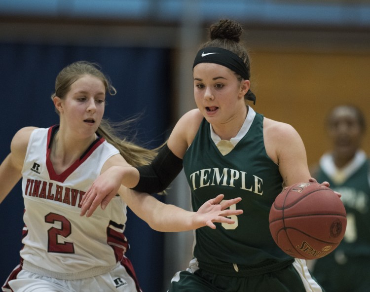 Temple's Veronica Rossignol beings the ball up the court as Vinalhaven's Ashlyn Littlefield applies pressure during a Class D South semifinal Thursday morning at the Augusta Civic Center.