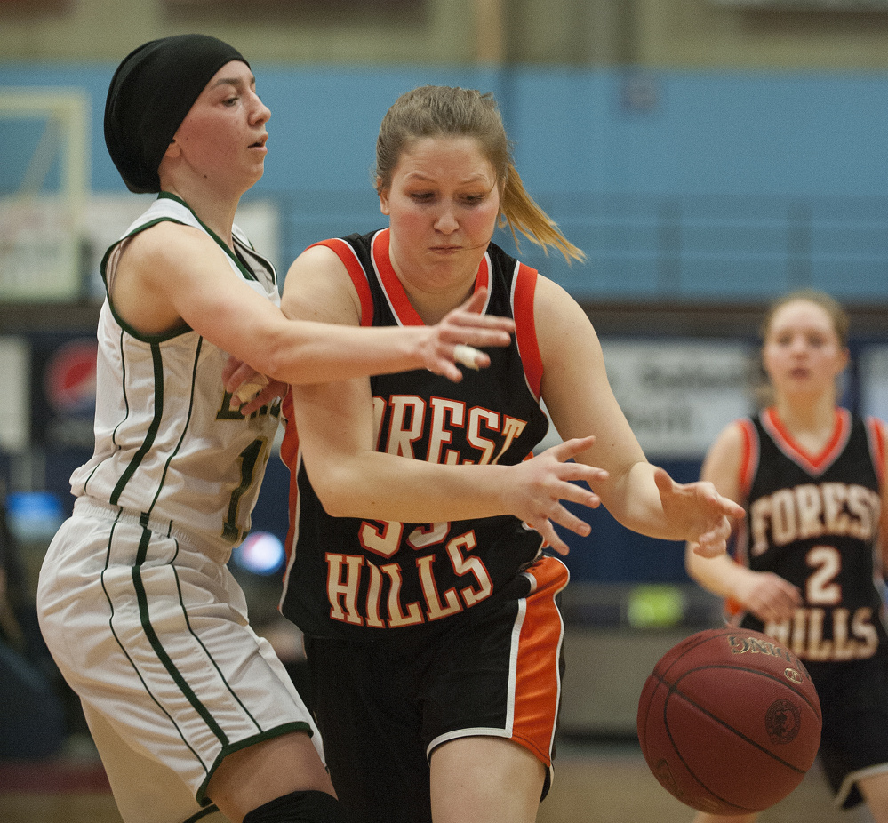 Photo by Kevin Bennett 
 Forest Hills' Madison Cuddy drives to the basket as Rangeley's Brooke Egan defends during a Class D semifinal Thursday at the Augusta Civic Center.