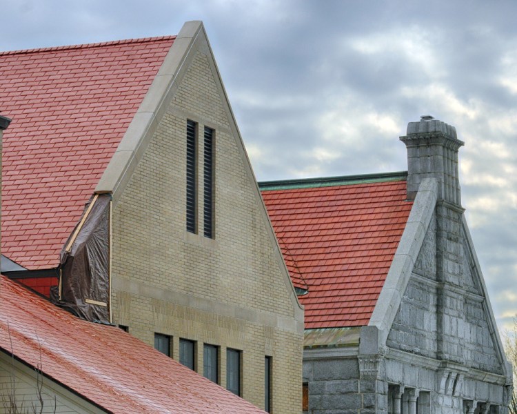 Tarps cover spots where masonry and roof flashing are missing Thusday on the west side of the new addition of Lithgow Public Library in Augusta. The original library building is at right.