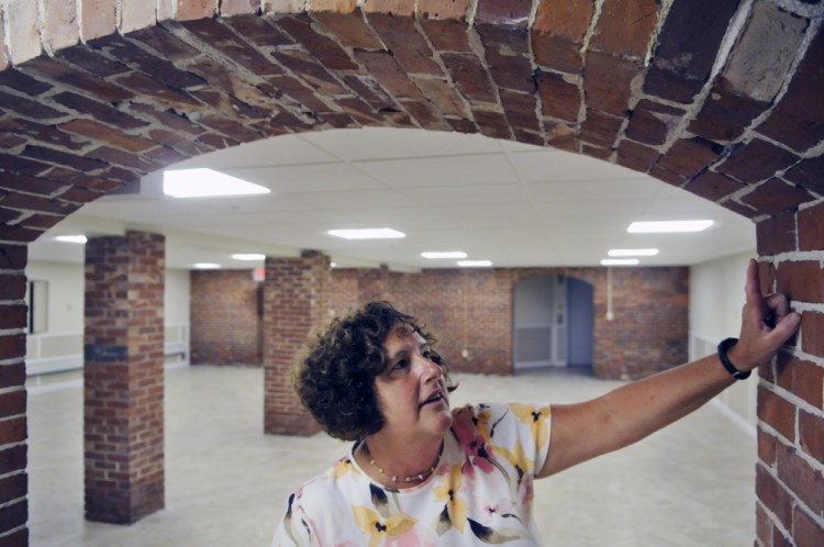 Gardiner Public Library Director Anne Davis, appointed interim city manager Wednesday, inspects brickwork in September 2015 in the archive room in the library's basement.