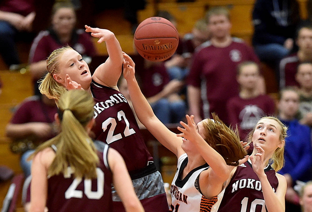 Nokomis sophomore Gabrielle Lord (22) fouls Skowhegan shooter Annie Cooke in the first half of a Class A North semifinal Wednesday afternoon at the Augusta Civic Center.