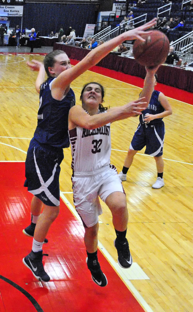 Old Orchard's Maggie Strohm, left, blocks a shot by Richmond's Mackenzie Abbott during a Class C semifinal game Thursday at the Augusta Civic Center.