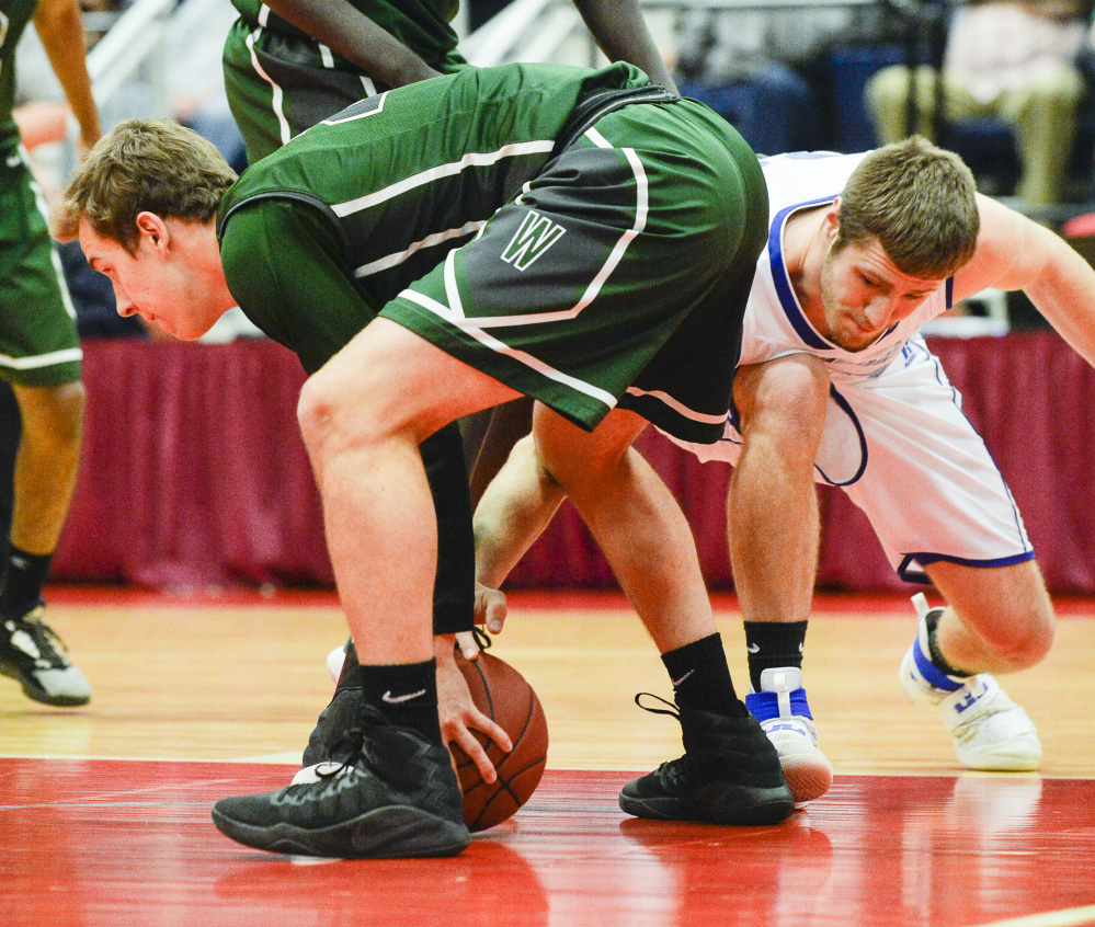 Madison's Mitch Jarvais attempts to recover the ball from Waynflete's Christian Brooks during the first quarter of a Class C South semifinal Thursday at the Augusta Civic Center.