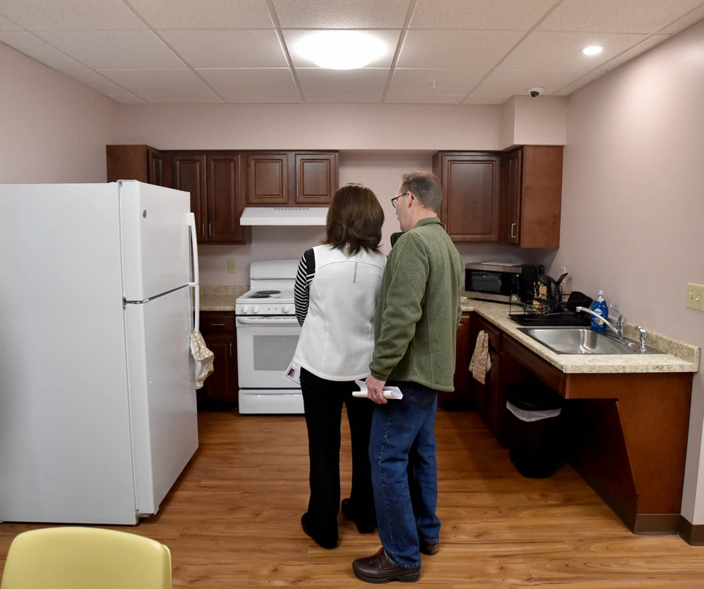 People tour the newly built apartments on the second floor of the Mid-Maine Homeless Shelter in Waterville on Friday.