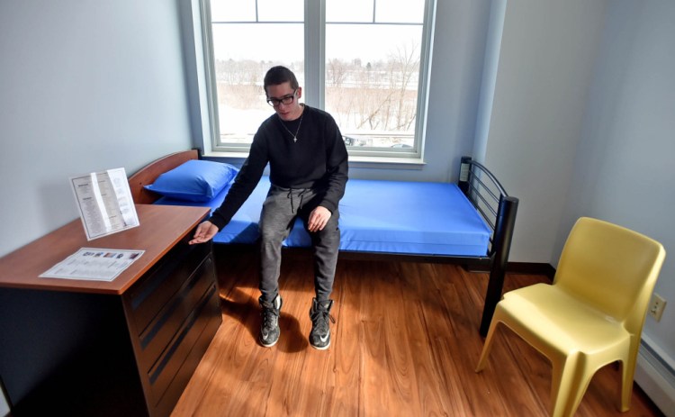Nicholas Turano, 20, offers a tour of an apartment he hopes to move into at the Mid-Maine Homeless Shelter on Colby Street in Waterville on Friday.