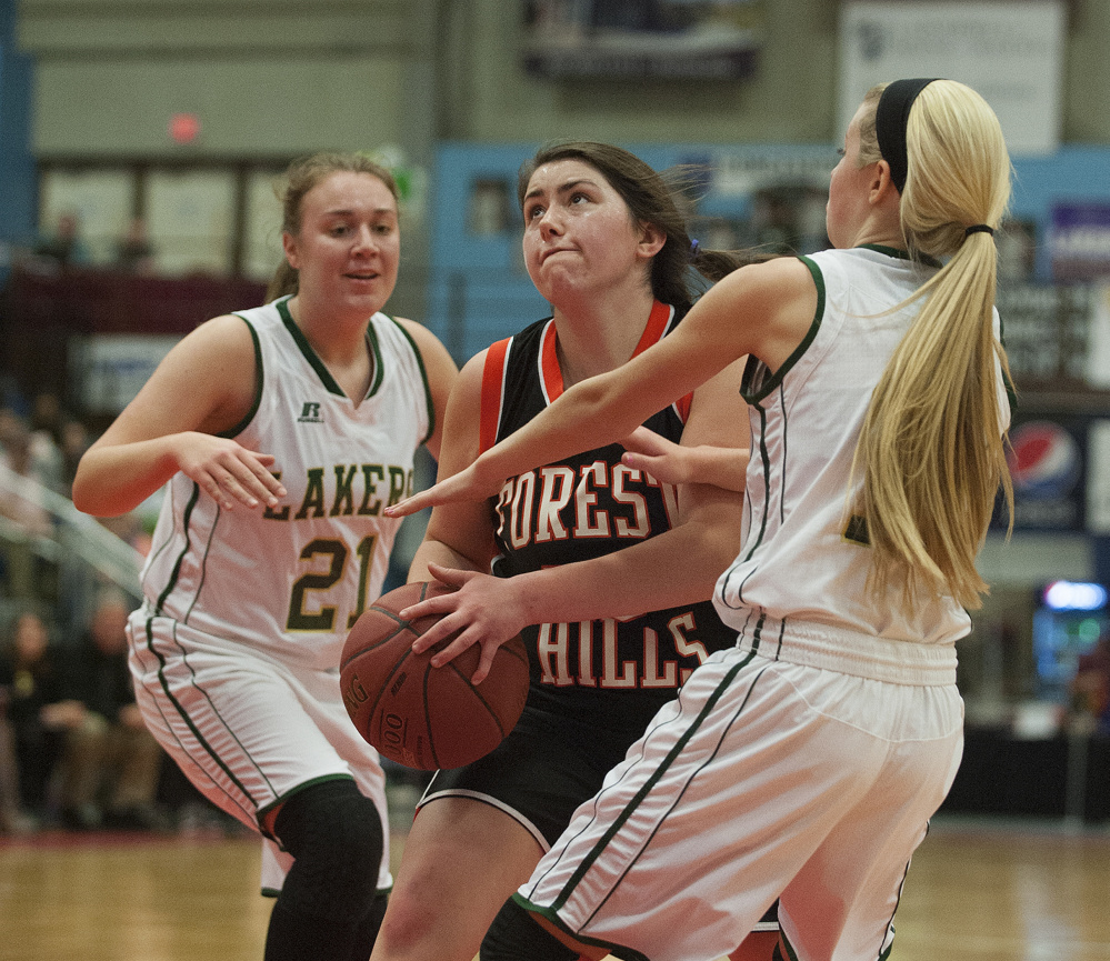 Kevin Bennett photo
Forest Hills' Patricia Lessard splits Rangely's Celia Philbrick, left and Lauren Eastlack, right, during a Class D South semifinal at the Augusta Civic Center in Augusta on Thursday.