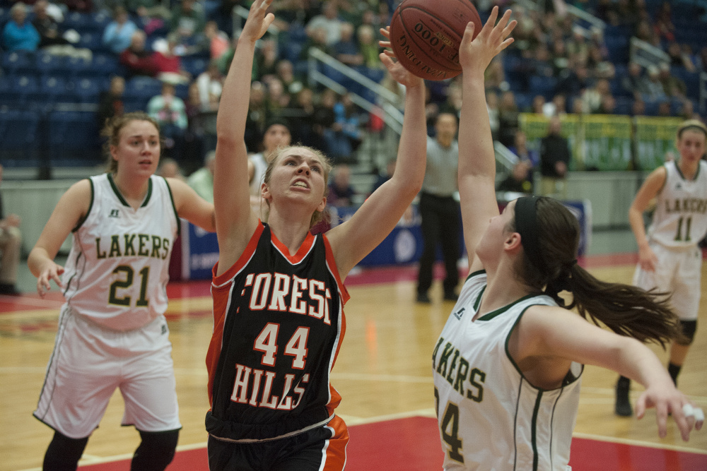 Forest Hills' Caitlin Logston and Rangely's Sydney Royce fight for a rebound during a Class D South semifinal at the Augusta Civic Center in Augusta on Thursday.