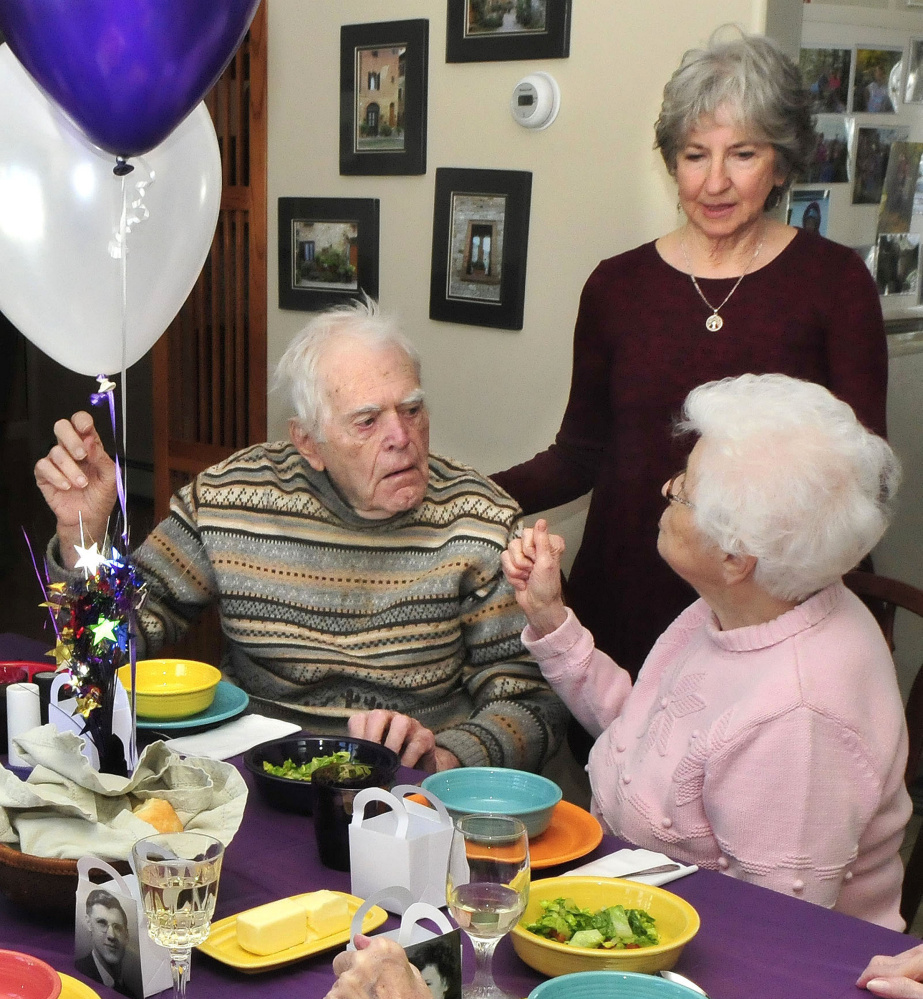 Party host Toni Ramundo speaks with two of the six members of the Waterville High School graduating class of 1942 who celebrated a reunion at Ramundo's home in Winslow on Monday. Classmates Burns Hillman and Dorothy Doucette chat about the old days during the party.