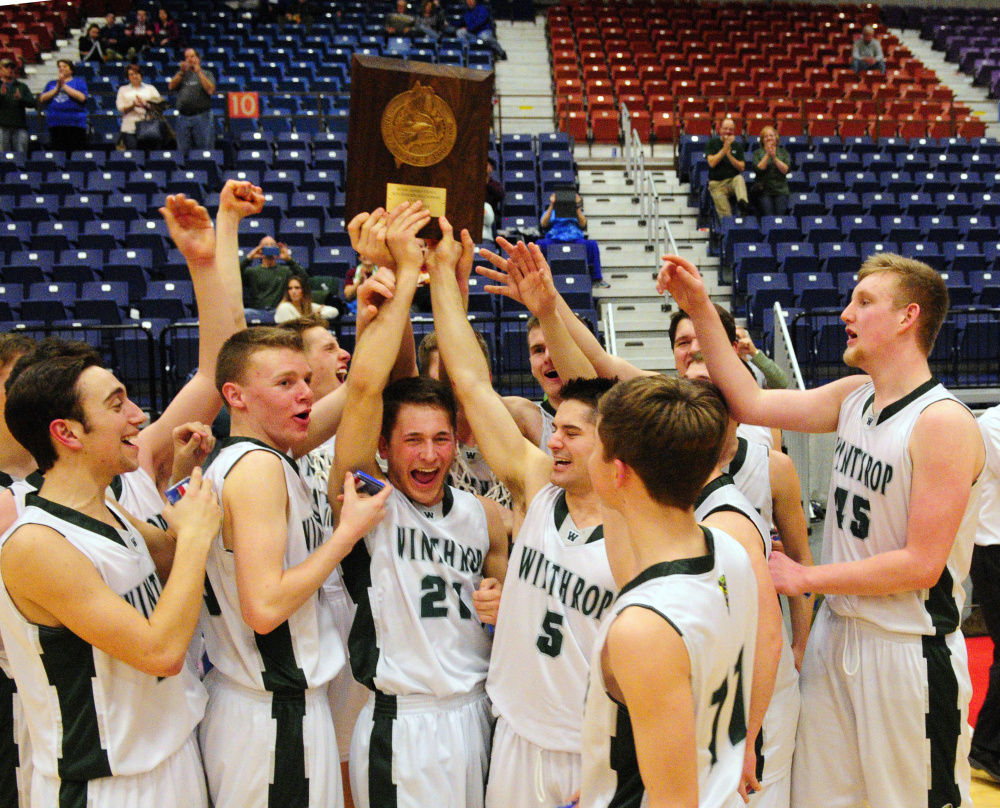 The Winthrop Ramblers hold up their championship plaque after defeating Madison to win the Class C South title Saturday  at the Augusta Civic Center.