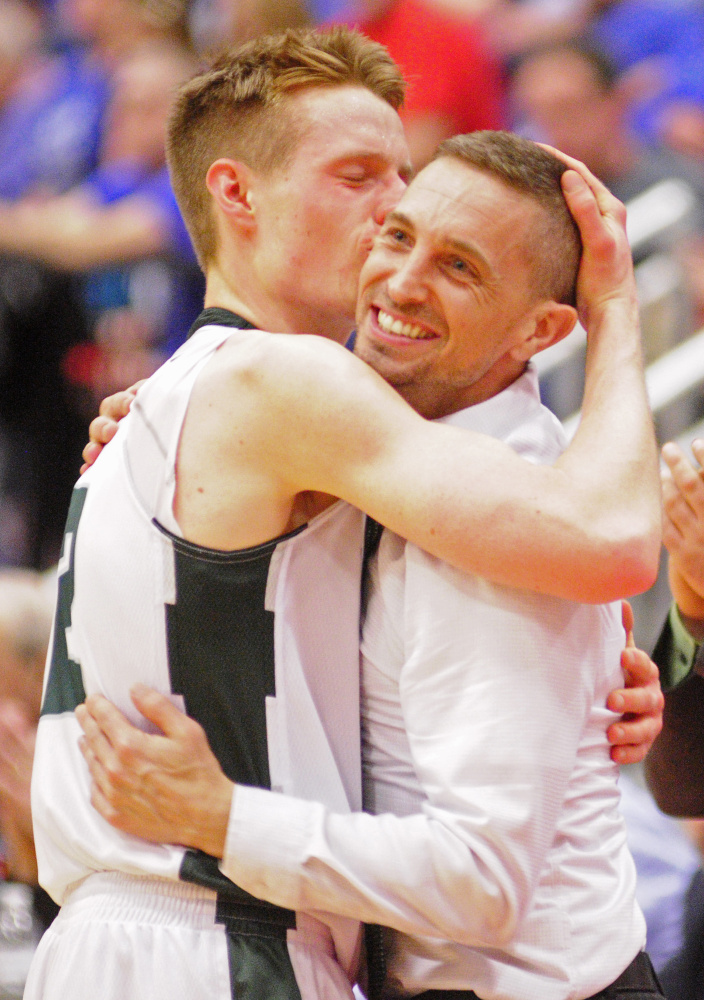 Winthrop coach Todd MacAurthur and Jacob Hickey embrace after the Class C South championship game Saturday at the Augusta Civic Center.