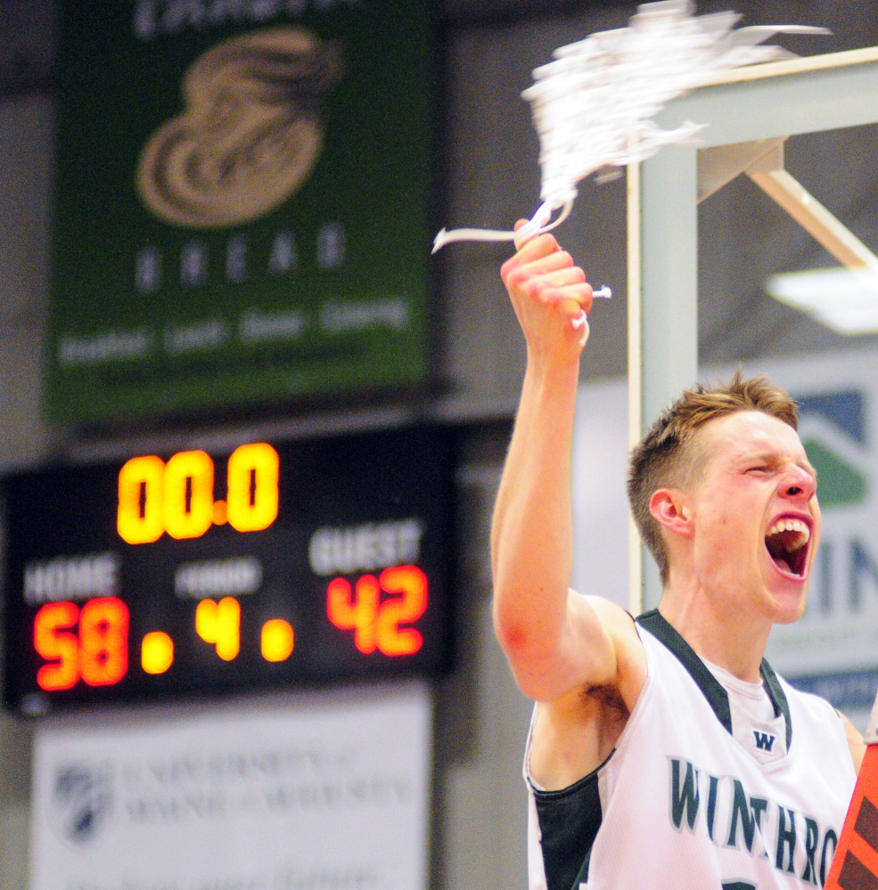 Winthrop's Jacob Hickey swings the net after the Ramblers beat Madison to win the Class C South title Saturday at the Augusta Civic Center.